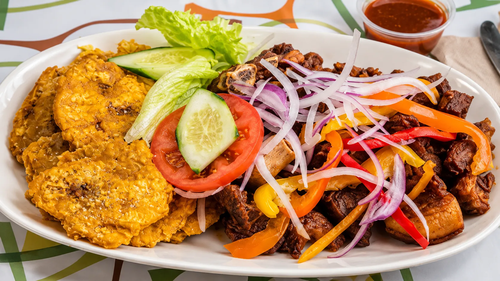 Haitian fritay with fried plantain, cassava and fried meat at Caribbean Latino Finger Licking Restaurant Edmonton